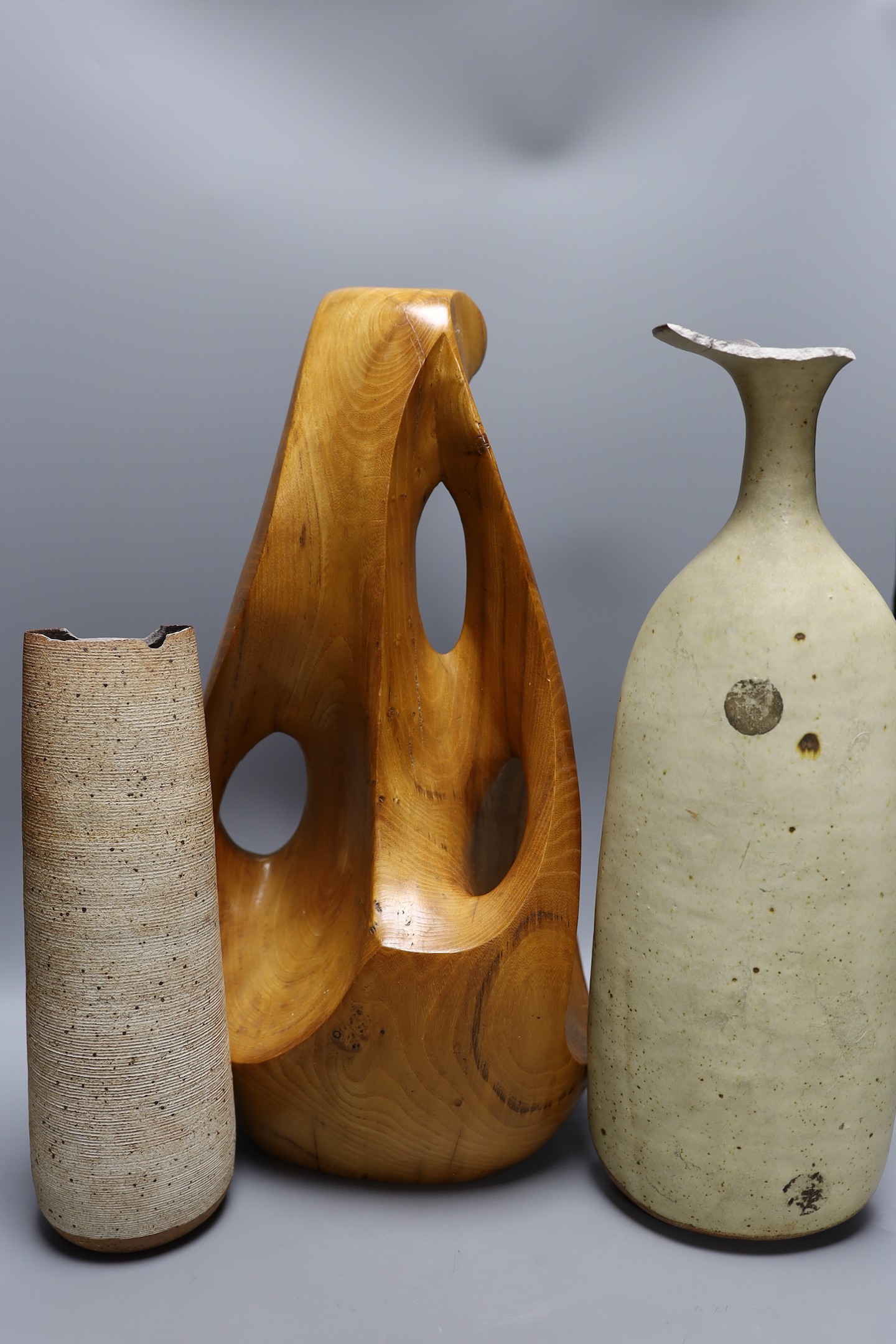 A carved elm abstract sculpture and two Joanna Constantinidis Studio pottery vases, tallest 44cm